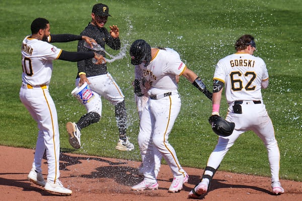 Pirates catcher Joey Bart, second from right, celebrates with teammates after driving in the winning run in Sunday's 4-3 victory over Atlanta.