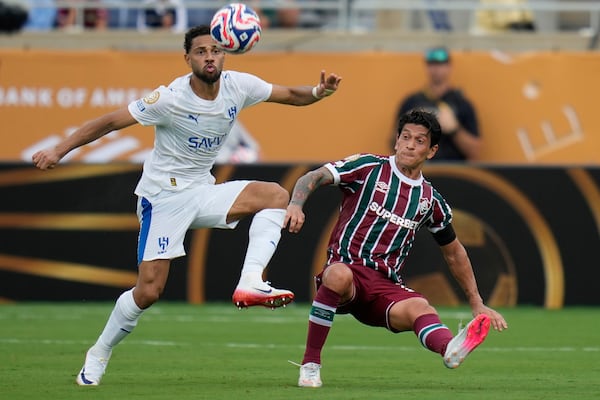 Al Hilal's Renan Lodi, left, and Fluminense's German Cano challenge for the ball during the Club World Cup quarterfinal soccer match between Fluminense and Al Hilal in Orlando, Fla., Friday, July 4, 2025. (AP Photo/John Raoux)