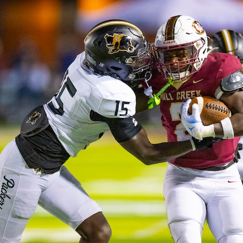 Mill Creek running back Jayde Beasley (2) runs against Colquitt County middle linebacker Davion Enoch (15) during the first half at Mill Creek Community Stadium, Friday, Nov. 14, 2025, in Hoschton, Ga. (Oscar Guevara Saenz for the AJC)