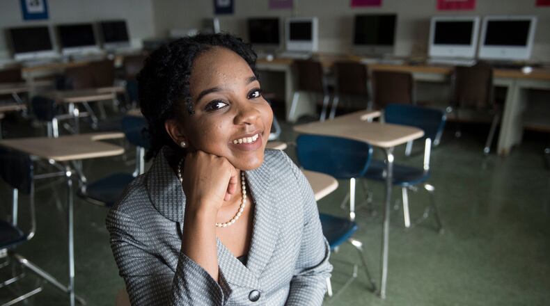 Elmont Memorial High School valedictorian Augusta Uwamanzu-Nna poses for a photo in an empty classroom in Elmont, N.Y. Uwamanzu-Nna has won acceptance to all 12 schools she applied for including all eight Ivy League universities. It’s the second time in as many years a student at the suburban New York high school has been accepted at all eight Ivy League universities.