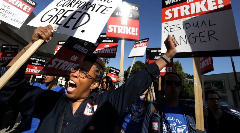 Actor and writer Daheli Hall, left, joins WGA members as they cheer on the first day of their strike in front of Paramount Studios on May 2, 2023, in Hollywood. (Genaro Molina/Los Angeles Times/TNS)
