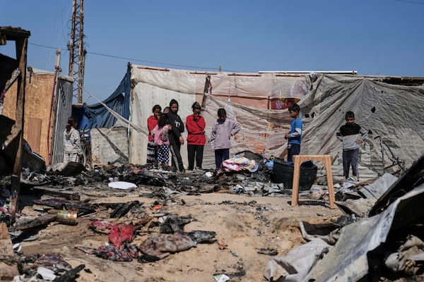 Palestinians inspect the remains of a displacement tent hit by an Israeli airstrike overnight, killing 10 members of the Abu Al-Rous family, in Khan Younis, southern Gaza Strip, Thursday, April 17, 2025. (AP Photo/Abdel Kareem Hana)