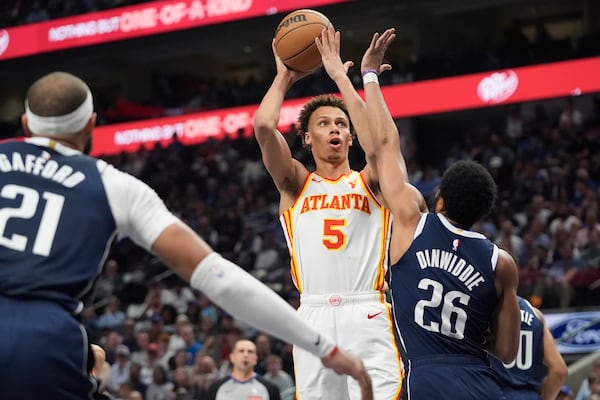 Atlanta Hawks guard Dyson Daniels (5) shoots against Dallas Mavericks defenders Spencer Dinwiddie (26) and Daniel Gafford (21) during the first half of an NBA basketball game in Dallas, Wednesday, April 2, 2025. (AP Photo/LM Otero)