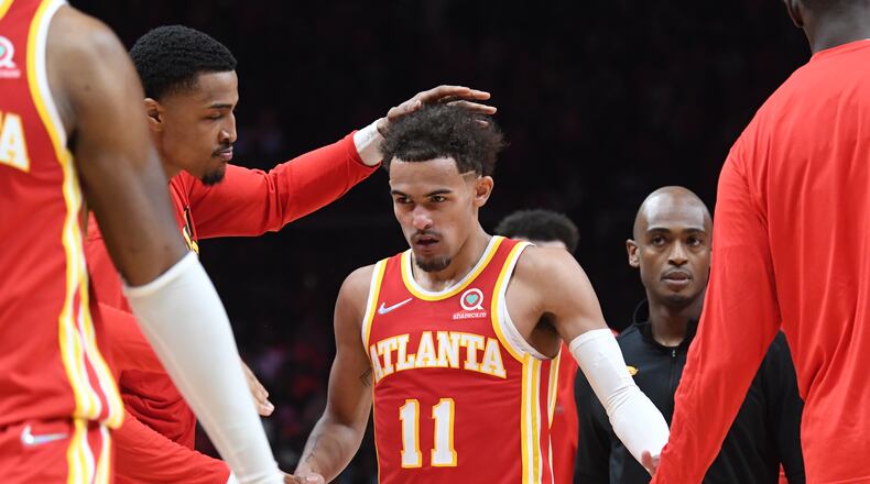 April 22, 2022 Atlanta -  Atlanta Hawks' guard Trae Young (11) is congratulated by a teammate after scoring the game winning shot at the end of the 4th quarter in Game 3 of the first round of the NBA playoffs at State Farm Arena on Friday, April 22, 2022. Atlanta Hawks won 111-110 over Miami Heat. (Hyosub Shin / Hyosub.Shin@ajc.com)