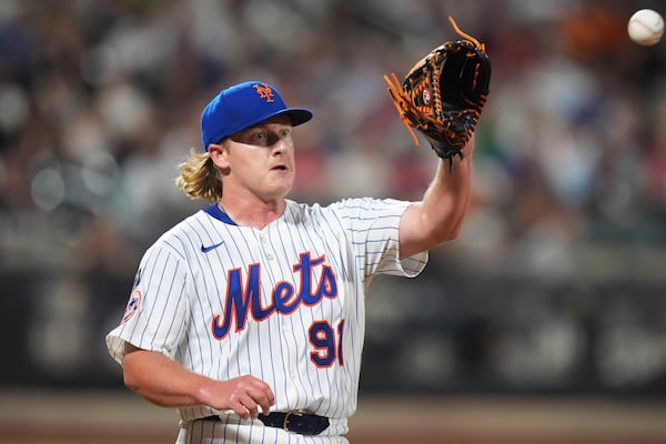 New York Mets pitcher Jonathan Pintaro covers first base for an out during the ninth inning of a baseball game against the Atlanta Braves Wednesday, June 25, 2025, in New York. (AP Photo/Frank Franklin II)