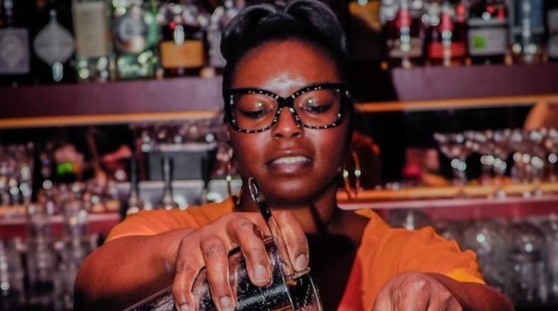Kia Palmer shaking up cocktails using Black owned spirits at Jo Jo's beloved Cocktail Lounge. /
Courtesy of Nate Refell