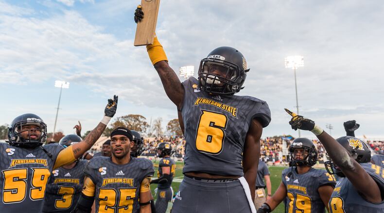 Kennesaw State's Akebren Ralls (6) lifts the "turnover plank" after a pick-six in Saturday's first-round FCS playoff game between Kennesaw State and Samford, Saturday, Nov. 25, 2017. (Special by Cory Hancock)