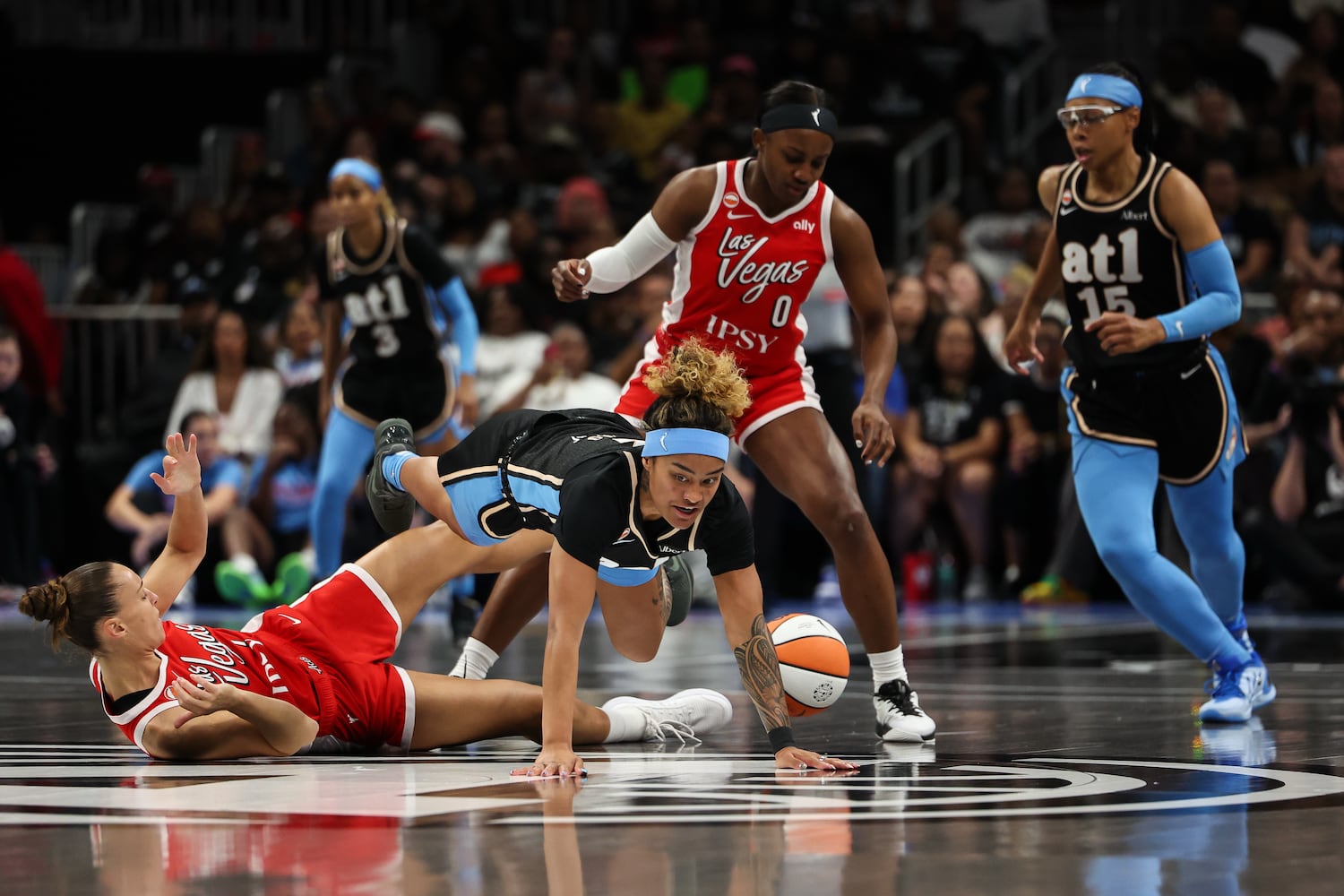 Dream guard Te-Hina Paopao (center bottom) fights for a loose ball against forward Stephanie Talbot (left) and guard Jackie Young (center top) during the first half Sunday, May 17, 2026, at State Farm Arena in Atlanta. (Colin Hubbard for the AJC) 
