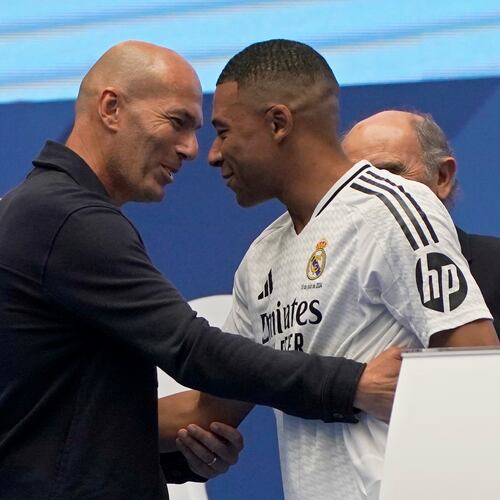 FILE - Former French player Zinedine Zidane, left, embraces Kylian Mbappe of France, as he is being presented to fans as a new Real Madrid player in Madrid, July 16, 2024. (AP Photo/Andrea Comas, File)