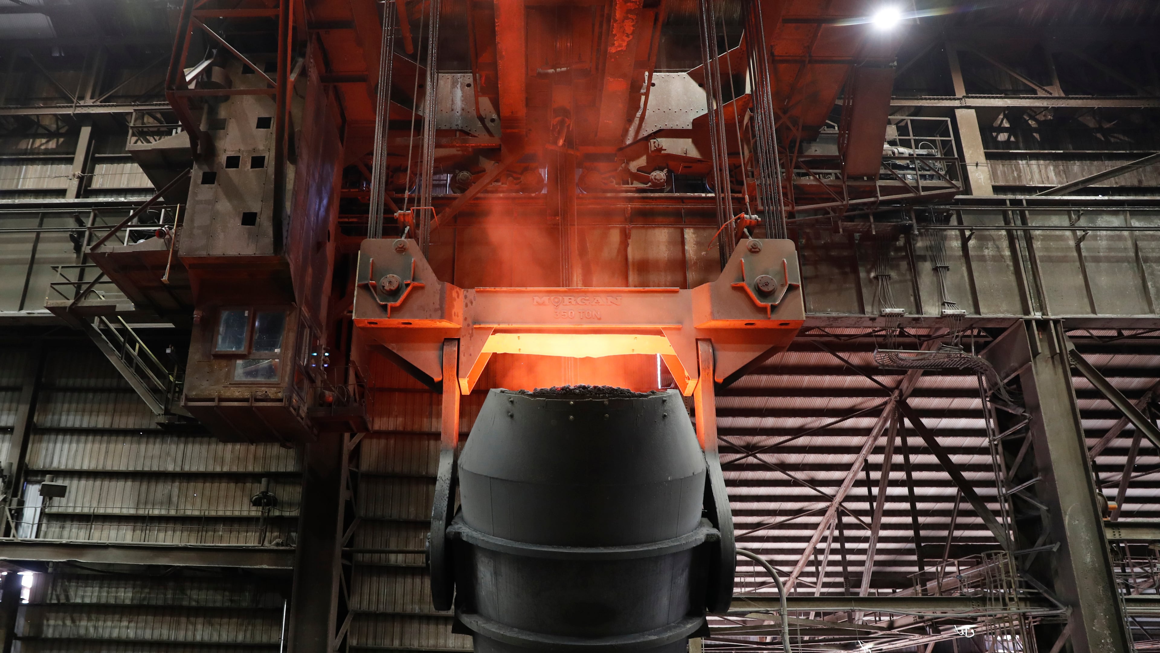 FILE - A giant ladle glows red after pouring molten iron in to a vessel inside the basic oxygen furnace as part of the processes of making steel at the U.S. Steel Granite City Works facility Thursday, June 28, 2018, in Granite City, Ill. (AP Photo/Jeff Roberson, File)