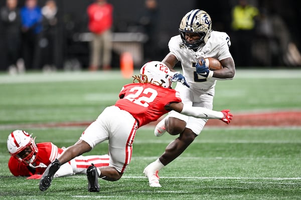 Thomas County Central running back Deuce Lawrence runs against Gainesville defensive back Syr Hunter during the first half of a Class 5A championship game Wednesday, Dec. 17, 2025 at Mercedes-Benz Stadium. (Daniel Varnado for the AJC)
