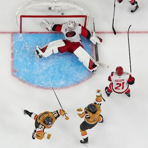 Vegas Golden Knights center William Karlsson (71) and Vegas Golden Knights right wing Mitch Marner (93) celebrate after Vegas Golden Knights defenseman Shea Theodore scored against Carolina Hurricanes goaltender Brandon Bussi (32) during the second overtime in Game 3 of the NHL hockey Stanley Cup Final series, Saturday, June 6, 2026, in Las Vegas. (AP Photo/John Locher)