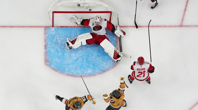 Vegas Golden Knights center William Karlsson (71) and Vegas Golden Knights right wing Mitch Marner (93) celebrate after Vegas Golden Knights defenseman Shea Theodore scored against Carolina Hurricanes goaltender Brandon Bussi (32) during the second overtime in Game 3 of the NHL hockey Stanley Cup Final series, Saturday, June 6, 2026, in Las Vegas. (AP Photo/John Locher)