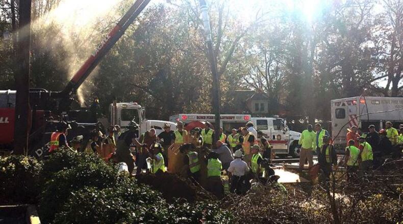 Crews worked Tuesday to free a Floyd County utility worker from a trench.