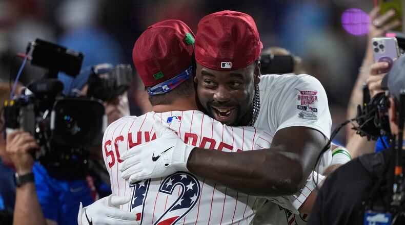 St. Louis Cardinals' Jordan Walker embraces Philadelphia Phillies' Kyle Schwarber after Walker won the MLB baseball All-Star Home Run Derby, Monday, July 13, 2026, in Philadelphia. (AP Photo/Matt Slocum)