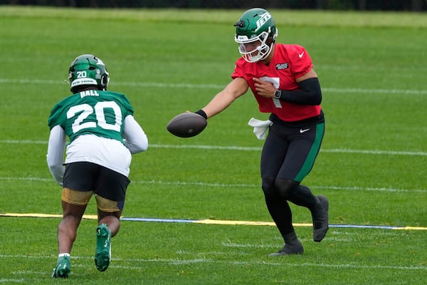 New York Jets quarterback Justin Fields (7) hands off to Breece Hall during an NFL football practice in Florham Park, N.J., Thursday, May 29, 2025. (AP Photo/Seth Wenig)