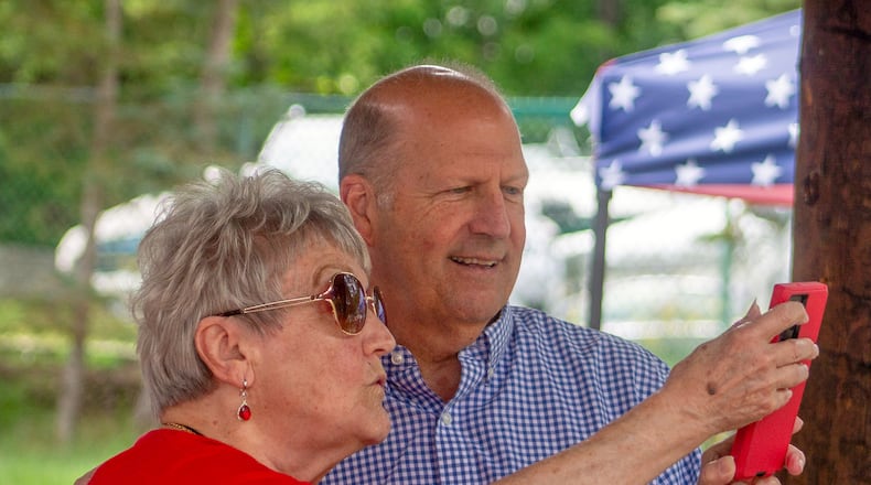 Former Sen. John E. Sununu, who is seeking the GOP nomination for his old seat, takes a selfie with supporter Sudie Francouer, in Berlin, N.H., Saturday, Aug. 22, 2026. (AP Photo/Holly Ramer)
