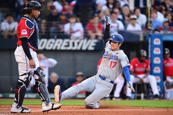 Los Angeles Dodgers' Shohei Ohtani (17) scores on an RBI single by Teoscar Hernandez (not shown) during the fifth inning of a baseball game against the Cleveland Guardians, Monday, May 26, 2025, in Cleveland. (AP Photo/David Dermer)