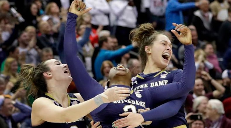 Notre Dame's Arike Ogunbowale, center, celebrates with teammates Marina Mabrey, left, and Kathryn Westbeld after defeating Mississippi State in the final of the women's NCAA Final Four college basketball tournament, Sunday, April 1, 2018, in Columbus, Ohio. Notre Dame won 61-58. (AP Photo/Tony Dejak)