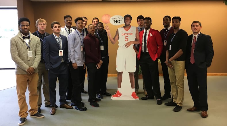 Dayton men’s basketball players pose with a cardboard cutout of Steve McElvene before McElvene’s funeral on Saturday, May 21, 2016, at Abundant Life Church in Fort Wayne, Ind. David Jablonski/Staff