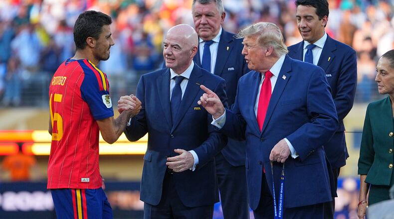 Spain's Rodri (16) is greeted by FIFA President Gianni Infantino and President Donald J. Trump during the presentation ceremony after the World Cup final soccer match between Spain and Argentina in East Rutherford, N.J., near New York, Sunday, July 19, 2026. (AP Photo/Julio Cortez)