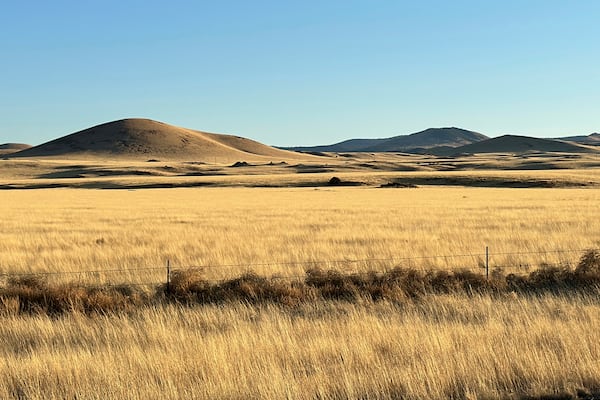The grasslands and rolling volcanic hills where an energy developer has proposed erecting more than 100 wind turbines, a project drawing opposition among residents in nearby Springerville, Ariz., is pictured Tuesday, April 22, 2025. (AP Photo/Susan Montoya Bryan)