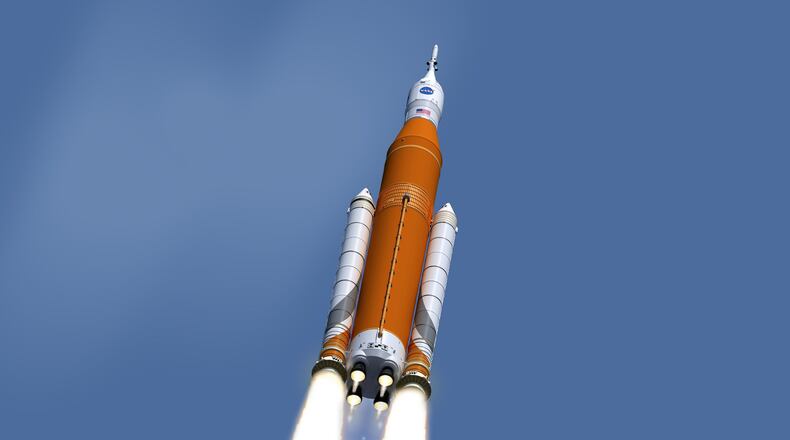 This image made available on Feb. 15, 2017 by NASA shows an artist’s concept of the launch of the Space Launch System rocket and Orion capsule. On Friday, Feb. 24, 2017, NASA said it is weighing the risk of adding astronauts to the first flight of its new megarocket. (NASA/Marshall Space Flight Center via AP)