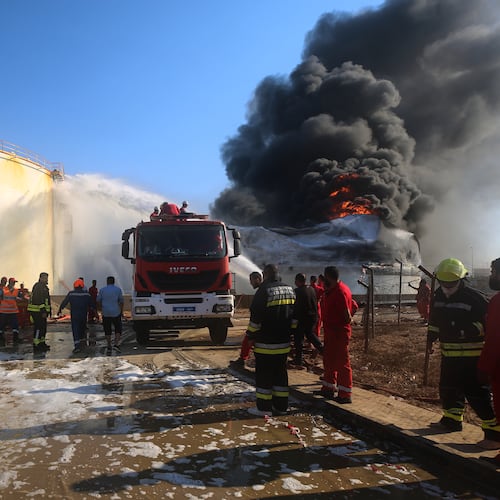 Firefighters work to contain a fire at the Zawiya oil refinery following a drone strike in Zawiya, Libya, Tuesday, Aug. 11, 2026. (AP Photo/Yousef Murad)