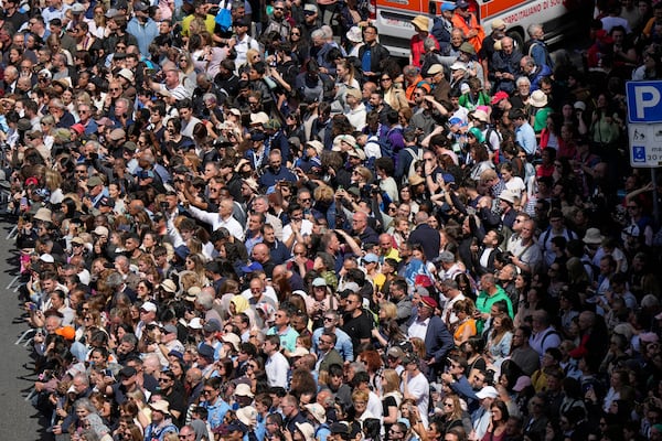 Faithful gather to follow the burial ceremony of Pope Francis at St. Mary Major Basilica in Rome, Saturday, April 26, 2025. (AP Photo/Luca Bruno)