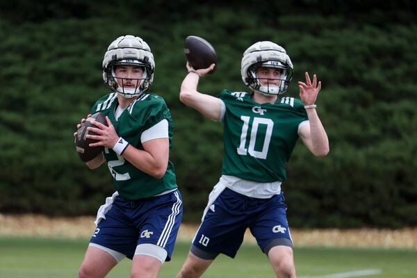 Quarterbacks Aaron Philo (left) and Haynes King attempt passes during spring football practice at Georgia Tech on Tuesday, March, 4, 2025, in Atlanta. If King is Batman, he has a Robin with him in Philo. (Jason Getz/AJC)
