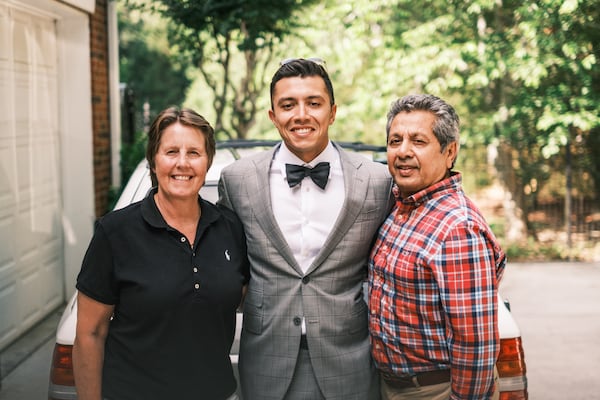 Professional race-car driver Shawn Rashid with his parents Diane Leonall and Noman Rashid on a recent visit home to Atlanta. Rashid is attempting to become a Formula 1 driver. (Photo courtesy Rory Butcher)