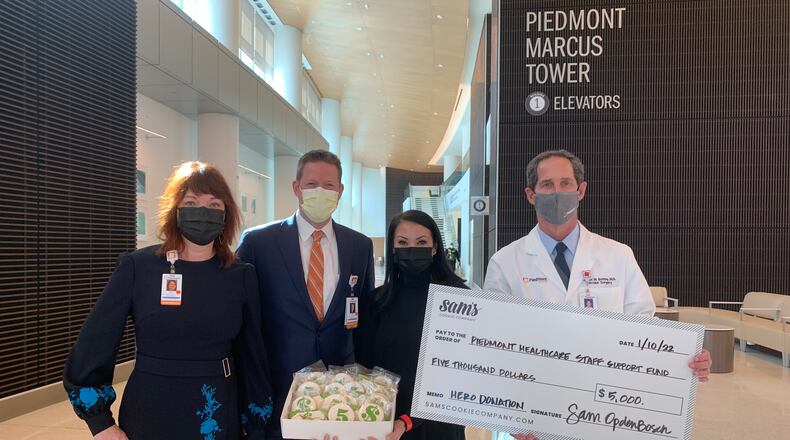 Marietta resident and winner of the “Christmas Cookie Challenge” Season 5, Episode 8
Reindeer Auditions on the Food Network, Sam Opdenbosch, owner of Sam’s Cookie Company, donated half of her winnings to a staff support fund at Piedmont Atlanta Hospital.
(L-R): Kelly Loftin, Piedmont Healthcare Foundation executive director; Josh Roberts, chief operating officer of Piedmont Atlanta Hospital; Sam Opdenbosch; Patrick M. Battey, M.D., chief executive officer of Piedmont Atlanta Hospital.