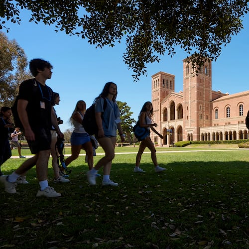 FILE - Students walk past Royce Hall on the UCLA campus in Los Angeles, Aug. 15, 2024. (AP Photo/Damian Dovarganes, File)