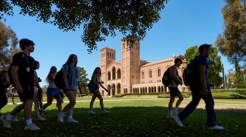 FILE - Students walk past Royce Hall on the UCLA campus in Los Angeles, Aug. 15, 2024. (AP Photo/Damian Dovarganes, File)