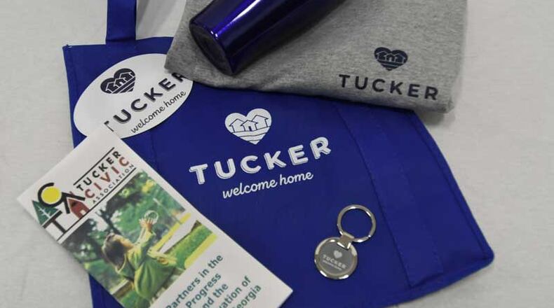 Tucker volunteers welcome new residents with a variety of city-branded items in reusable shopping bags. (Courtesy of Tucker)
