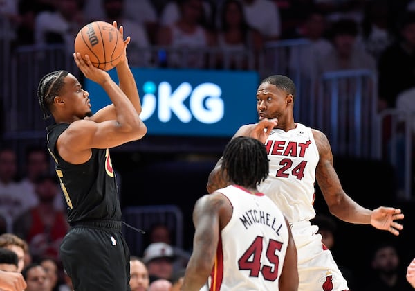 Cleveland Cavaliers forward Isaac Okoro shoots over Miami Heat forward Haywood Highsmith (24) during the first half in Game 3 of an NBA basketball first-round playoff series, Saturday, April 26, 2025, in Miami. (AP Photo/Michael Laughlin)