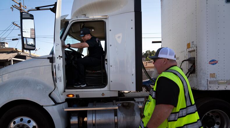 FILE - A student driver gets on a truck as the instructor watches in Calif., Nov. 15, 2021. (AP Photo/Jae C. Hong, File)