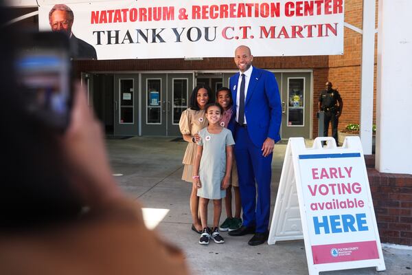 Jason Esteves, a Democratic candidate for governor, smiles for a photo with his family after voting early at the C.T. Martin Natatorium & Recreation Center last week. (Abbey Cutrer/AJC)