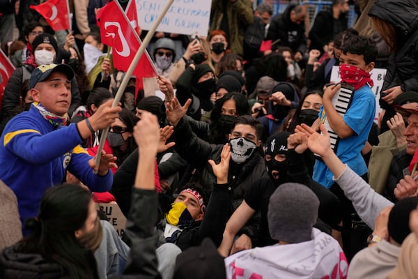 People shout slogans as they gather outside Istanbul's city hall in Istanbul, Turkey, Monday, March 24, 2025, to protest after Istanbul's Mayor Ekrem Imamoglu was arrested and sent to prison. (AP Photo/Khalil Hamra)