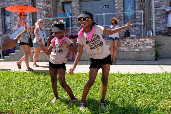 Kelsea and Kennedy Branford watch during a Juneteenth parade Thursday, June 19, 2025, in Galveston, Texas. (AP Photo/David J. Phillip)