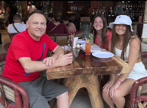 This Dec. 2021 photo provided by Jazzmin Kernodle shows father Jeff Kernodle, left, Xana, middle, and Jazzmin, in Puerto Vallarta, Mexico. (Courtesy of Jazzmin Kernodle via AP)