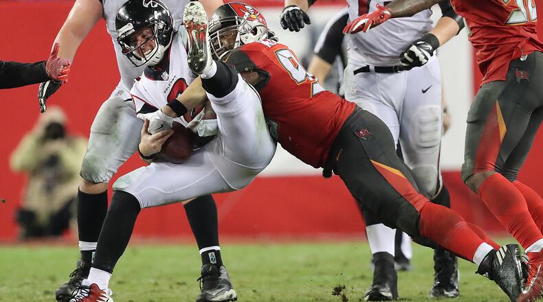 December 18, 2017 Tampa: Falcons quarterback Matt Ryan barely holds on to the football on a sack by Buccaneers Clinton McDonald during a third down play in the final minutes of a NFL football game on Monday, December 18, 2017, in Tampa. The Falcons held on to beat the Bucs 24-21. Curtis Compton/ccompton@ajc.com