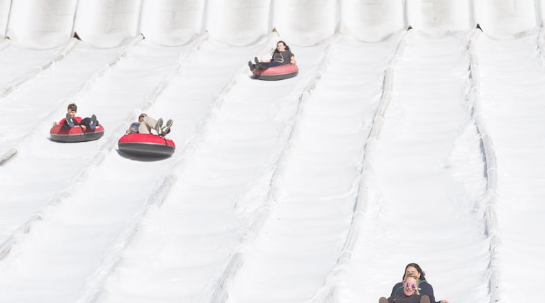 People head down the 400-foot tubing hill at Snow Mountain in Stone Mountain Park. Credit: Steve Schaefer