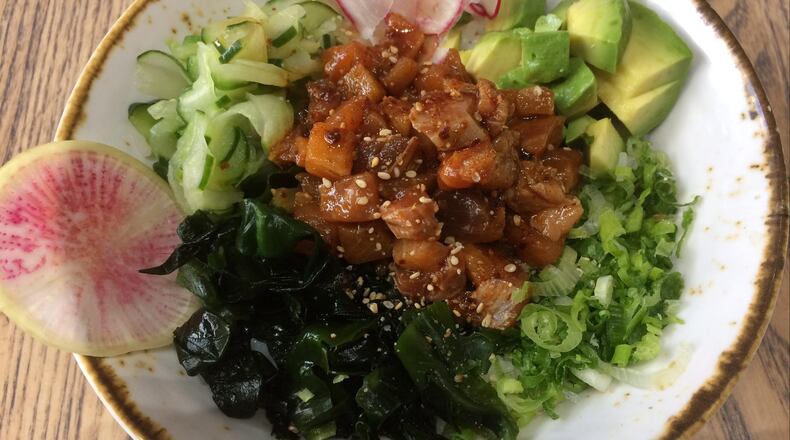 The poke bowl at Momonoki comes with a mixture of bluefin tuna, salmon and yellowtail, plus avocado, scallions, radishes, pickled daikon, and pickled cucumber. CONTRIBUTED BY WENDELL BROCK