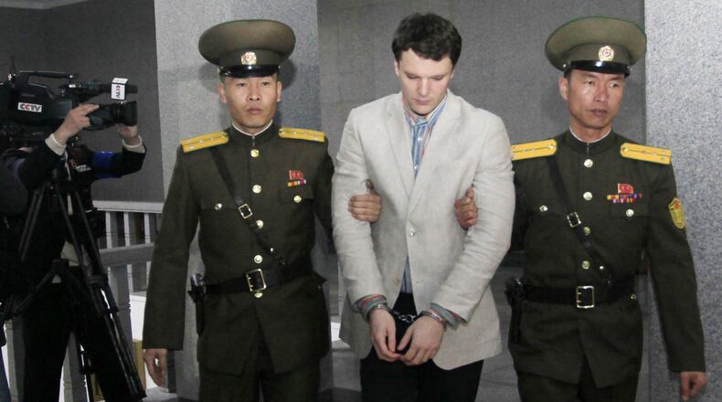 American student Otto Warmbier, center, is escorted at the Supreme Court in Pyongyang, North Korea, Wednesday, March 16, 2016. North Korea's highest court sentenced Warmbier, a 21-year-old University of Virginia undergraduate student, from Wyoming, Ohio, to 15 years in prison with hard labor on Wednesday for subversion. He allegedly attempted to steal a propaganda banner from a restricted area of his hotel at the request of an acquaintance who wanted to hang it in her church. (AP Photo/Jon Chol Jin)