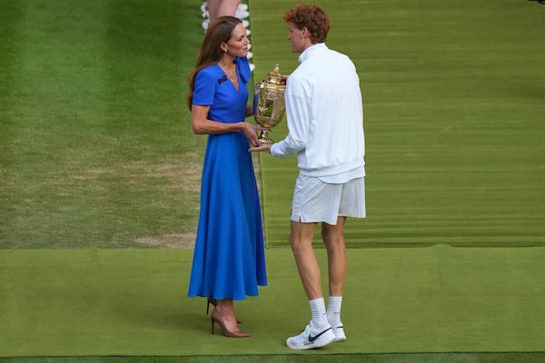 Italy's Jannik Sinner receives the trophy from Kate, Princess of Wales, after beating Carlos Alcaraz of Spain to win the men's singles final at the Wimbledon Tennis Championships in London, Sunday, July 13, 2025. (AP Photo/Joanna Chan)