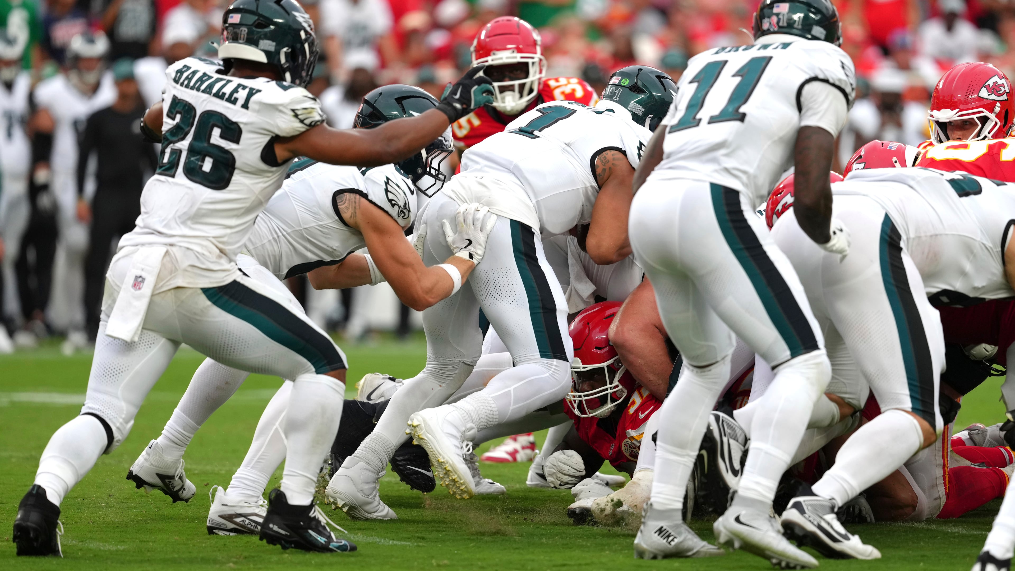 Philadelphia Eagles quarterback Jalen Hurts (1) gets a push from behind from Philadelphia Eagles tight end Grant Calcaterra (81) agains the Kansas City Chiefs in the second half during an NFL football game Sunday, Sept. 14, 2025, in Kansas City, Mo. (AP Photo/Ed Zurga)