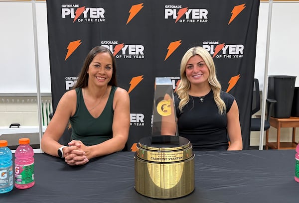 Softball legend Cat Osterman presented former Buford standout pitcher Caroline Stanton with the 2025-2026 Gatorade National Softball Player of the Year trophy at Buford High School on Tuesday, June 9, 2026. (Jack Leo/AJC)