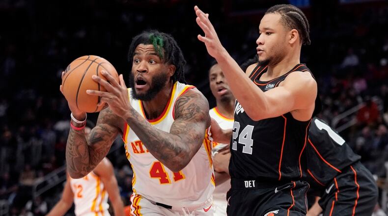 Atlanta Hawks forward Saddiq Bey (41) passes the ball as Detroit Pistons forward Kevin Knox II (24) defends during the first half of an NBA basketball game, Tuesday, Nov. 14, 2023, in Detroit. (AP Photo/Carlos Osorio)