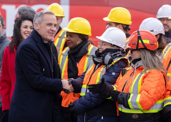 Liberal Leader Mark Carney greets workers as he arrives at a campaign event at the Port of Montreal on Friday March 28, 2025. (Frank Gunn/The Canadian Press via AP)